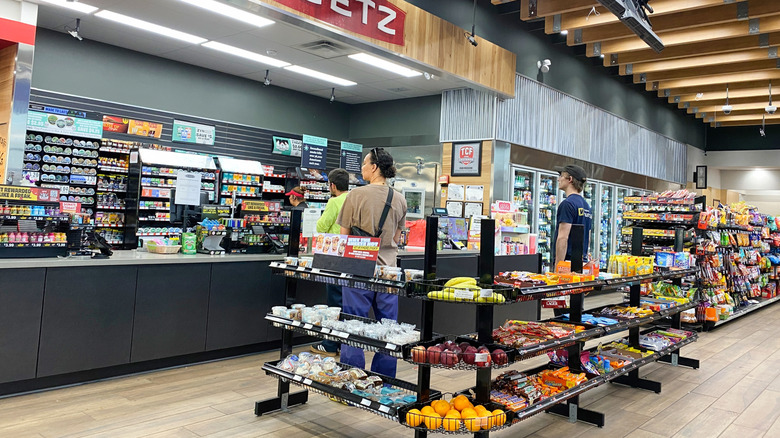 Customers wait to check out inside of a Sheetz gas station