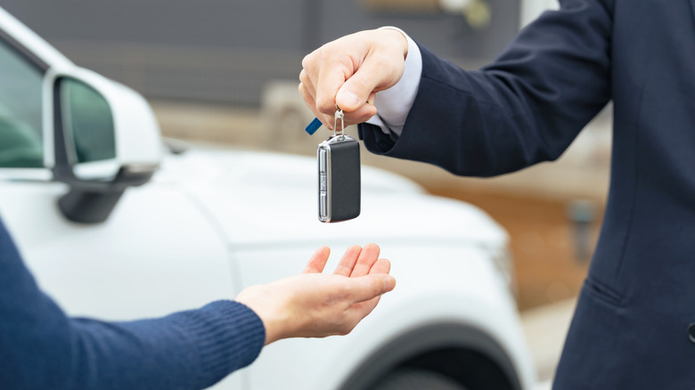 Person getting keys to their rental car