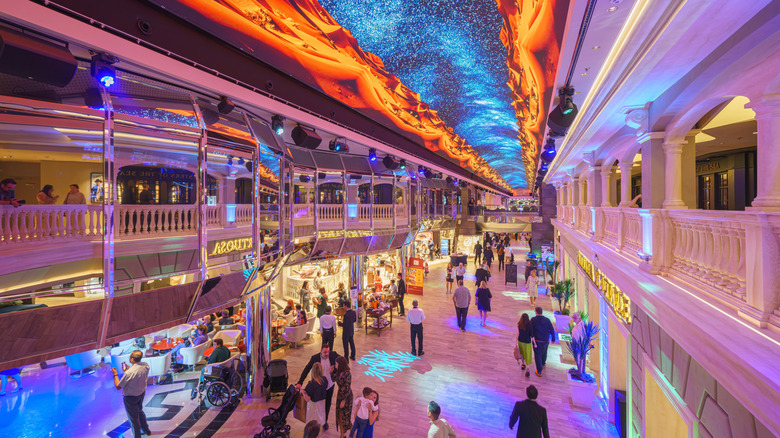 The interior atrium shops brightly lit up on an MSC cruise liner