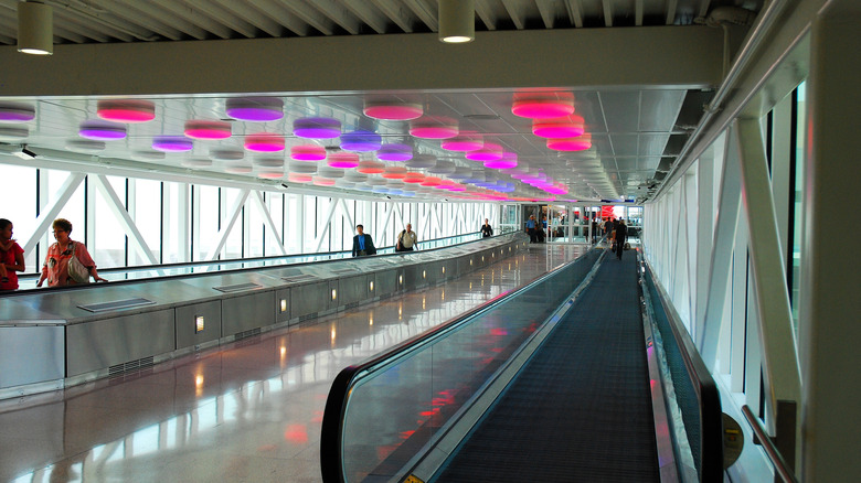 Colorful lights on the ceiling of a pedestrian bridge at Indianapolis airport