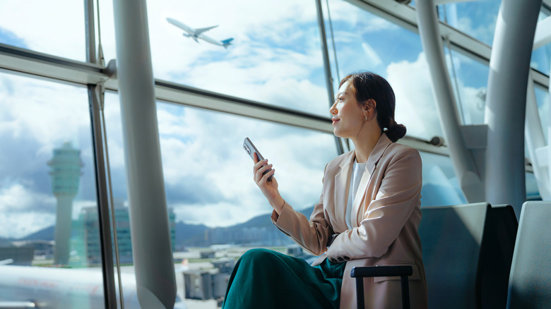 A businesswoman sitting in an airport terminal