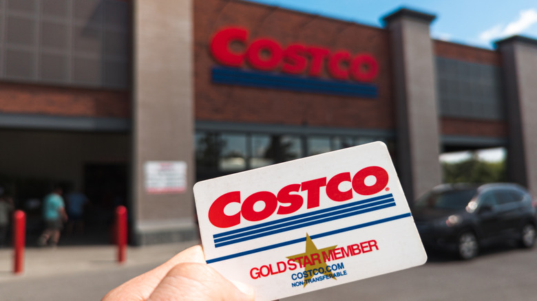 Costco member holding Costco card