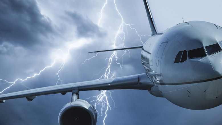 A plane flies through lightning