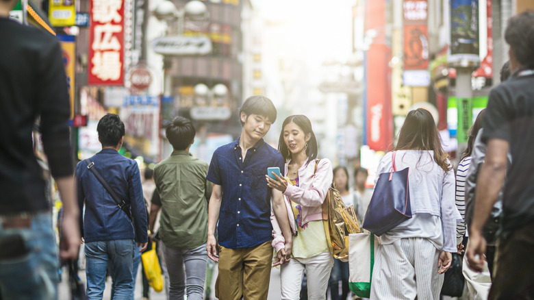 couple in tokyo street holding hands