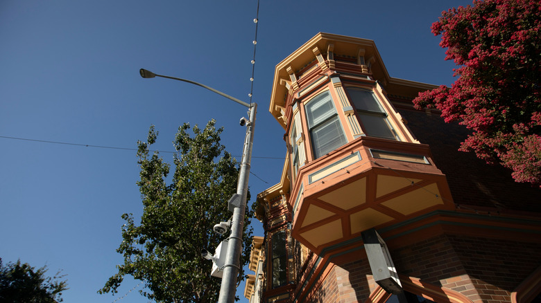 Historic Victorian-style building in downtown Hollister, California, viewed from street level against a clear blue sky