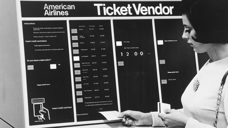A vintage photo of a woman using an American Airlines ticket vending machine