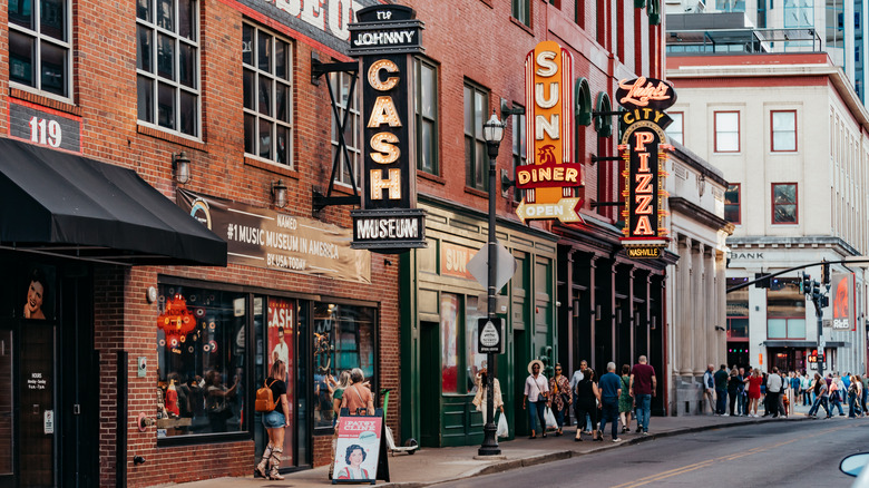 People walking in downtown Nashville near the Johnny Cash museum during the day