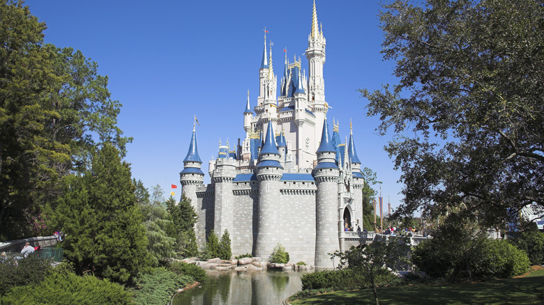 Exterior side view of Cinderella Castle in the Fantasyland area of Magic Kingdom theme park at Walt Disney World Resort in Orlando, Florida, USA, pictured on a bright, cloudless day