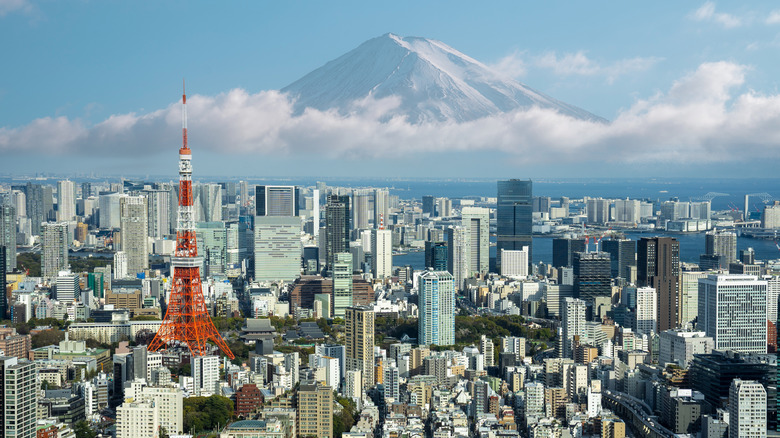 Mt Fuji behind clouds and the Tokyo skyline