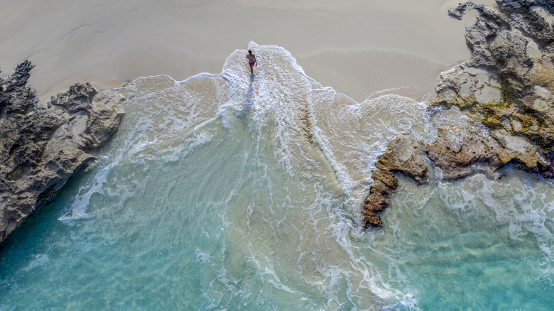 A woman on a deserted Bahamas beach
