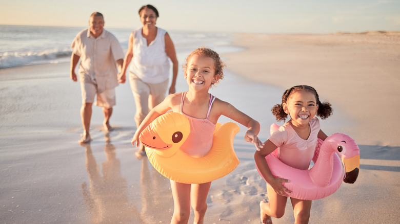 A family beach walk with grandkids at sunset in Hawaii