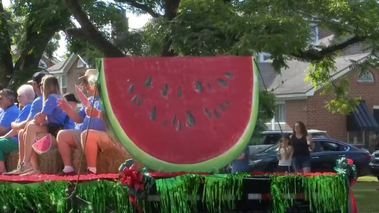 People riding a watermelon themed float in Cordele