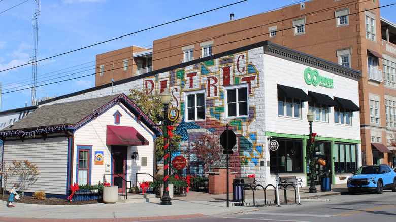 A view of commercial building, including one with a mural, in Carmel, Indiana