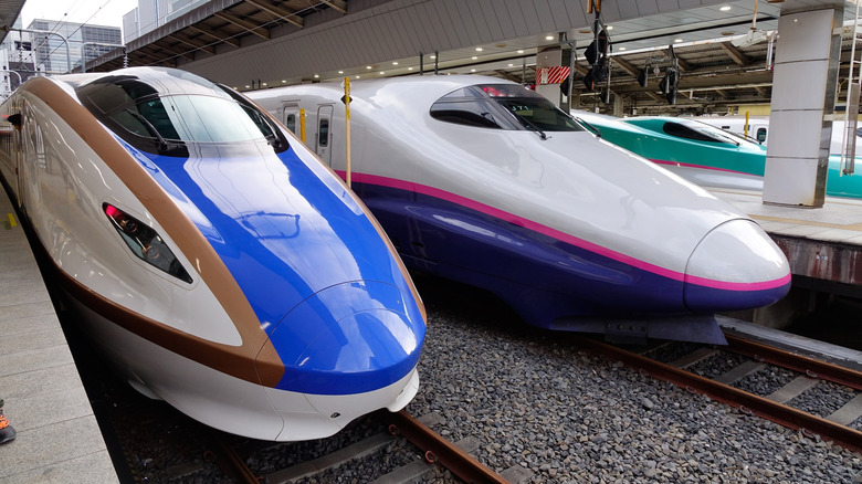 Three bullet trains parked at a Tokyo platform