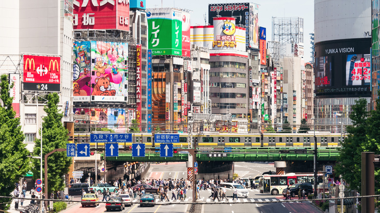 A train passes over a bridge by Shinjuku Station