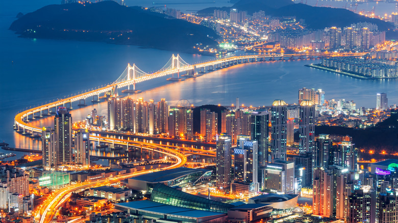 view of sea surrounding the nighttime cityscape of Busan south korea
