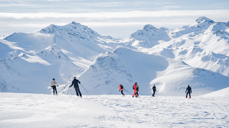 Austrian mountains completely covered in snow with a few skeirs