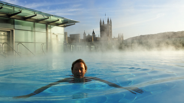 Woman swimming in rooftop spa in Bath