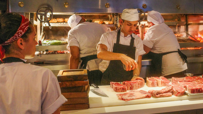 Chef seasoning steaks at Don Julio