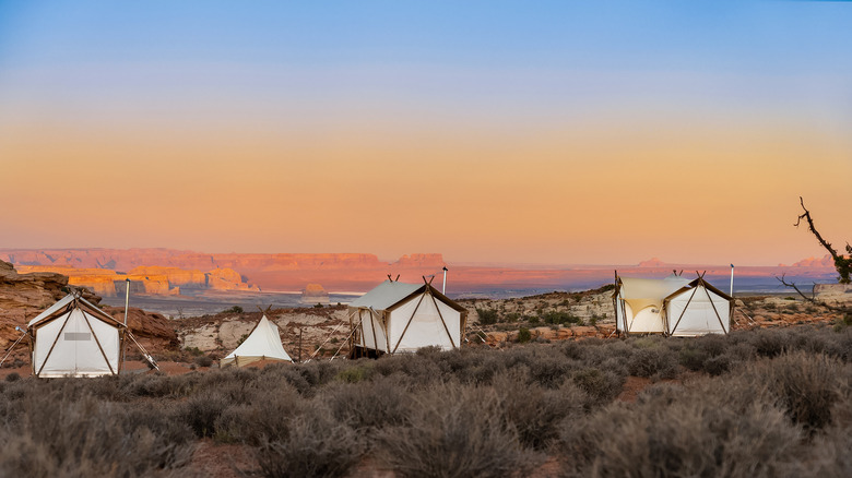 View of the white canvas tents of Under Canvas Lake Powell — Grand Staircase, a glamping retreat at the edge of Grand Staircase-Escalante National Monument in Utah, USA
