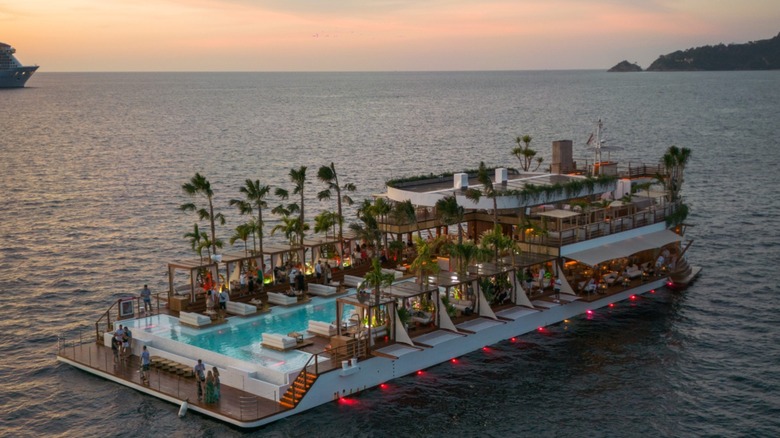 Landscape view of Yona Beach Club, floating in the Andaman Sea off of Phuket, Thailand, at sunset