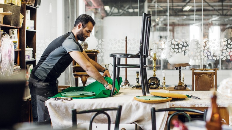 Worker repairing furniture at ReTuna