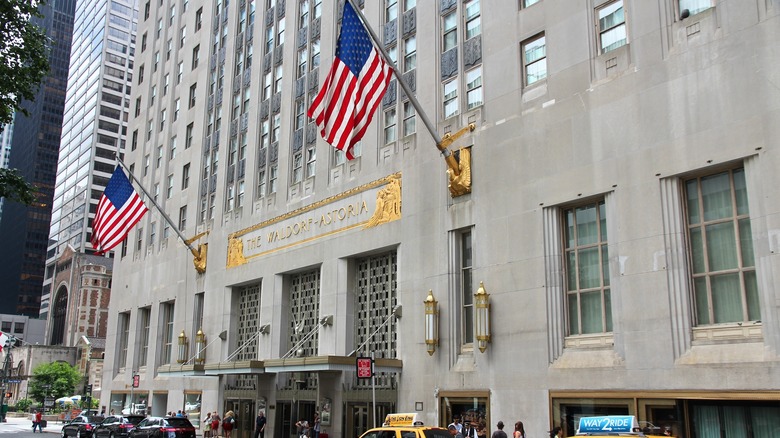 Hotel facade with flags and taxis