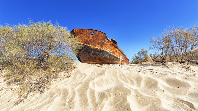 A ship perched atop smooth dunes in the former Aral Sea