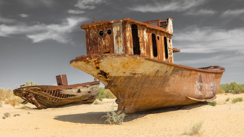 Fishing boats stand in the desert of the former Aral Sea