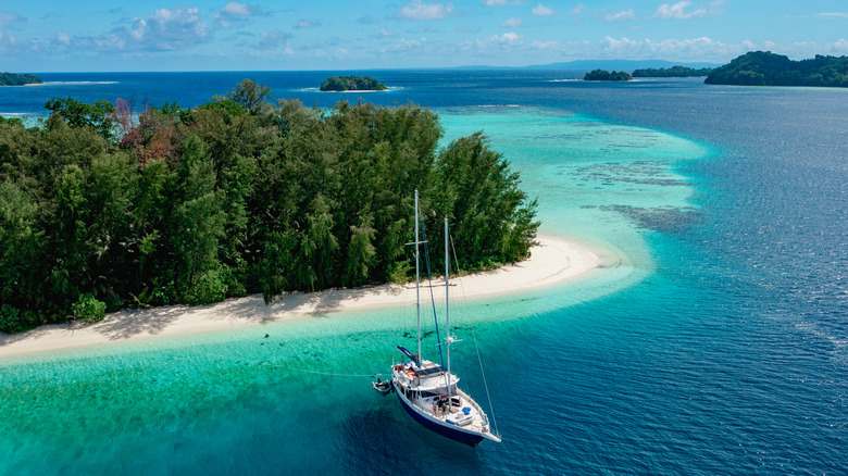 Aerial view of a yacht moored in a bay in the Solomon Islands during the day