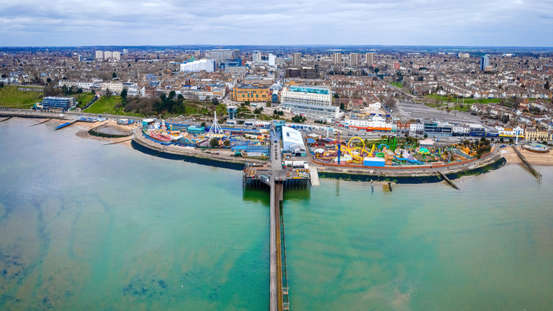 Southend Pier and Railway in Southend-on-Sea, UK, jutting out into water from amusement rides
