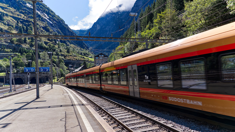 Train at Gotthard Base Tunnel in Switzerland, with mountains behind
