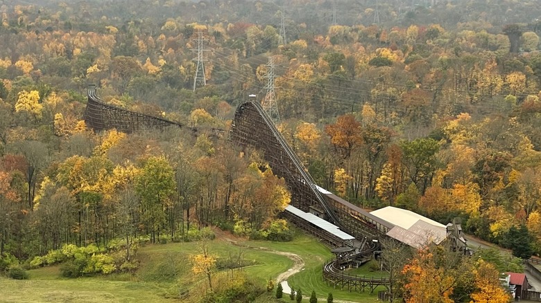 The Beast roller coaster seen from above surrounded by fall foliage