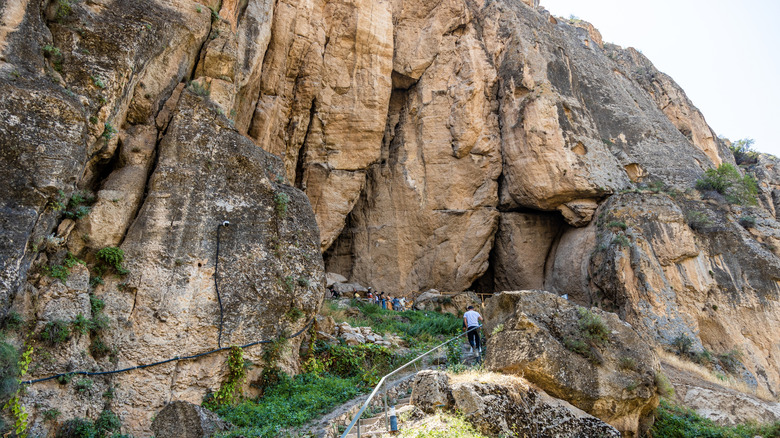 Tourists heading into the Areni-1 cave complex in Areni, Armenia on a bright summer day