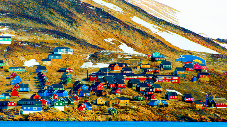 Colorful houses dot the glacial slopes of a remote village in Greenland