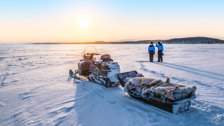 Two loaded sledges over a frozen Lake Inari