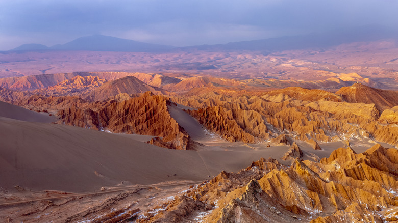 Red sandy peaks dot the landscape of a totally arid Atacama Desert