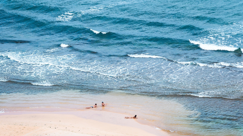 People relaxing on Nyang Nyang Beach, Bali, Indonesia.