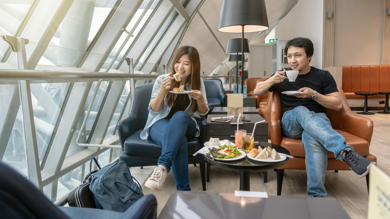 Asian couple eating at an airport lounge