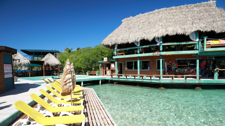 View of Little French Key resort building, lounge chairs, and water