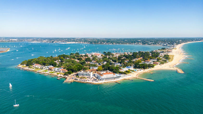 Sandbanks Beach and Millionaires Row from above on a sunny day with Poole Harbour in background