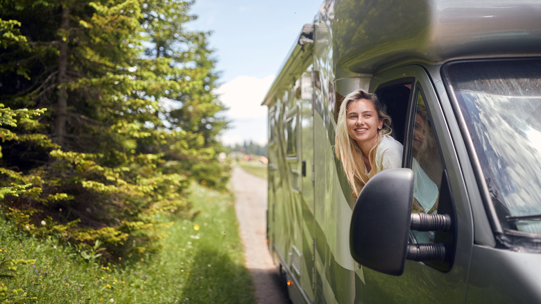 Woman smiling looking out RV window