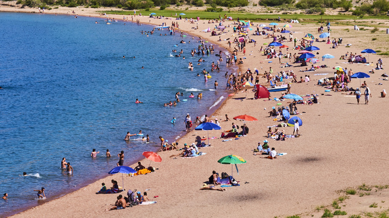 Tourists relaxing on the sandy beaches of Issyk-Kul