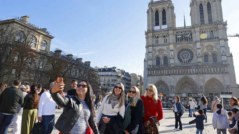 Tourists taking selfie at Notre Dame Cathedral