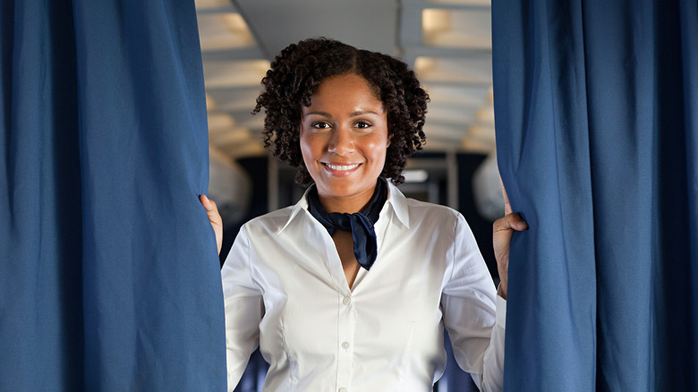 Flight attendant smiling on a plane