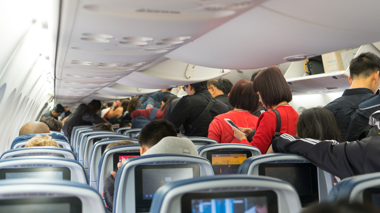 People waiting to get off a plane