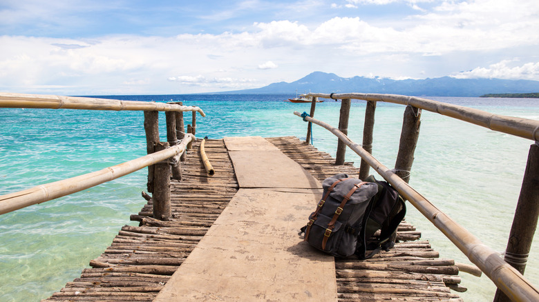 Backpacks on a pier overlooking the ocean