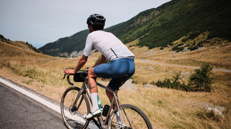 A cyclist biking along the Transfagarasan Road in the Fagaras Mountains