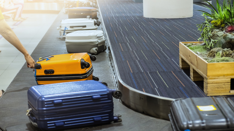 Suitcases on a conveyor belt at baggage claim