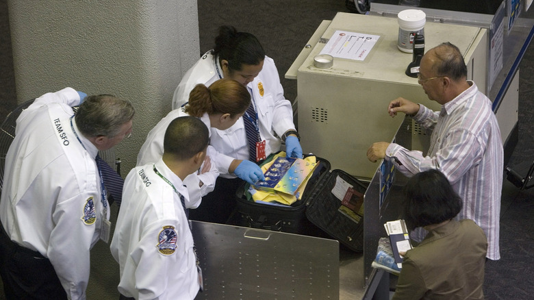 San Francisco International Airport security staff checking someone's bag